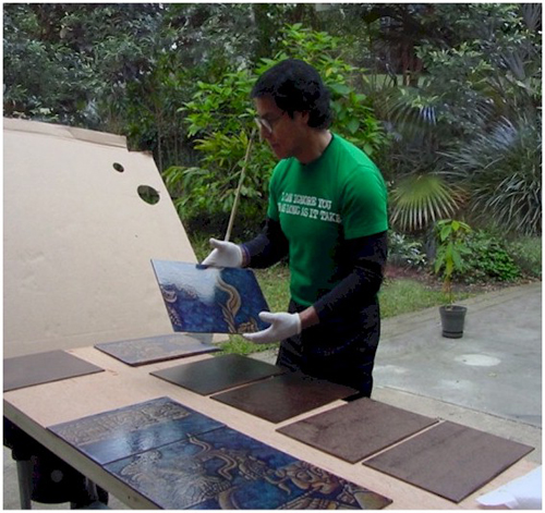 Artist Andreas Mujica working on his mural The Silence and the Glory